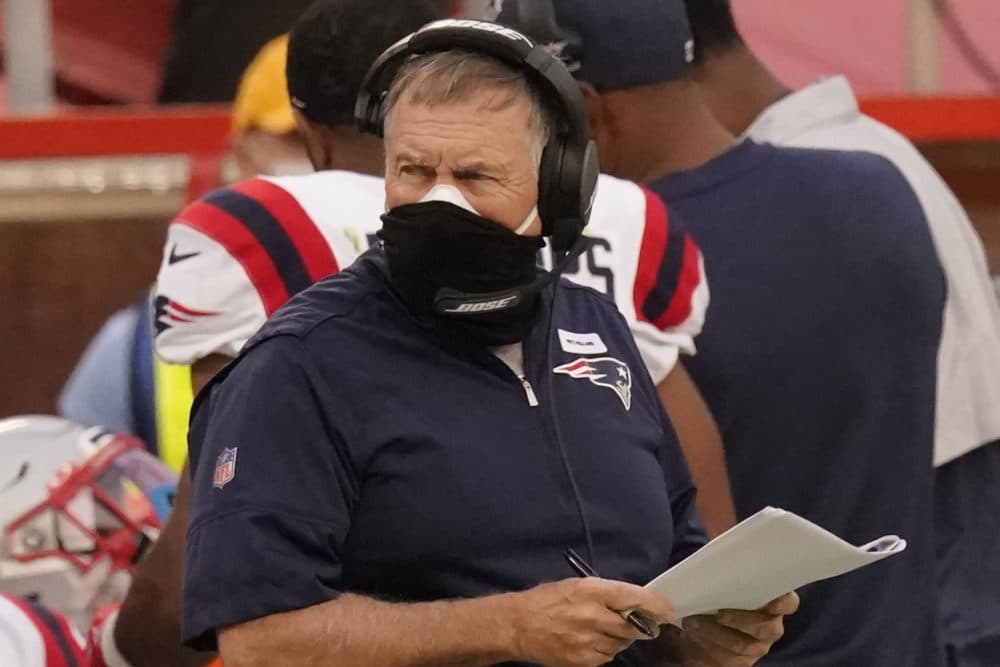New England Patriots head coach Bill Belichick wears two masks as he watches from the sideline during the first half of an NFL football game against the Kansas City Chiefs, Oct. 5, 2020, in Kansas City. (Charlie Riedel/AP)