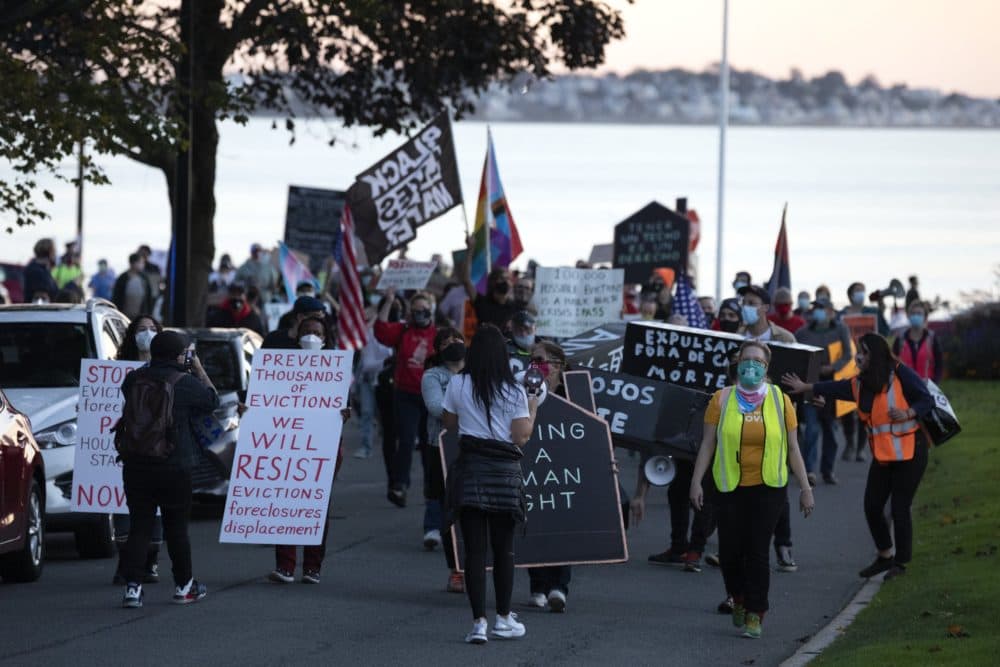 Housing activists march to Gov. Charlie Baker's house, Wednesday, Oct. 14, 2020, in Swampscott, Mass. The protesters were calling on the governor to support more robust protections against evictions and foreclosures during the ongoing coronavirus pandemic. (Michael Dwyer/AP)