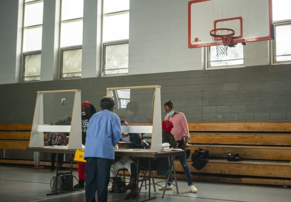 Poll workers sit behind plexiglass barriers during primary elections on June 2, 2020 in Philadelphia, Pennsylvania. (Jessica Kourkounis/Getty Images)