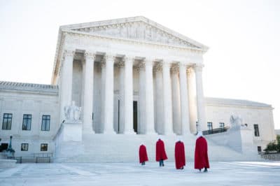 Protesters from the Center for Popular Democracy Action, dressed in Handmaid's Tale costumes, walk across the plaza of the U.S. Supreme Court in Washington on Wednesday, Sept. 30, 2020, to voice opposition to Judge Amy Coney Barrett's nomination to the Supreme Court (Bill Clark/CQ-Roll Call, Inc via Getty Images)