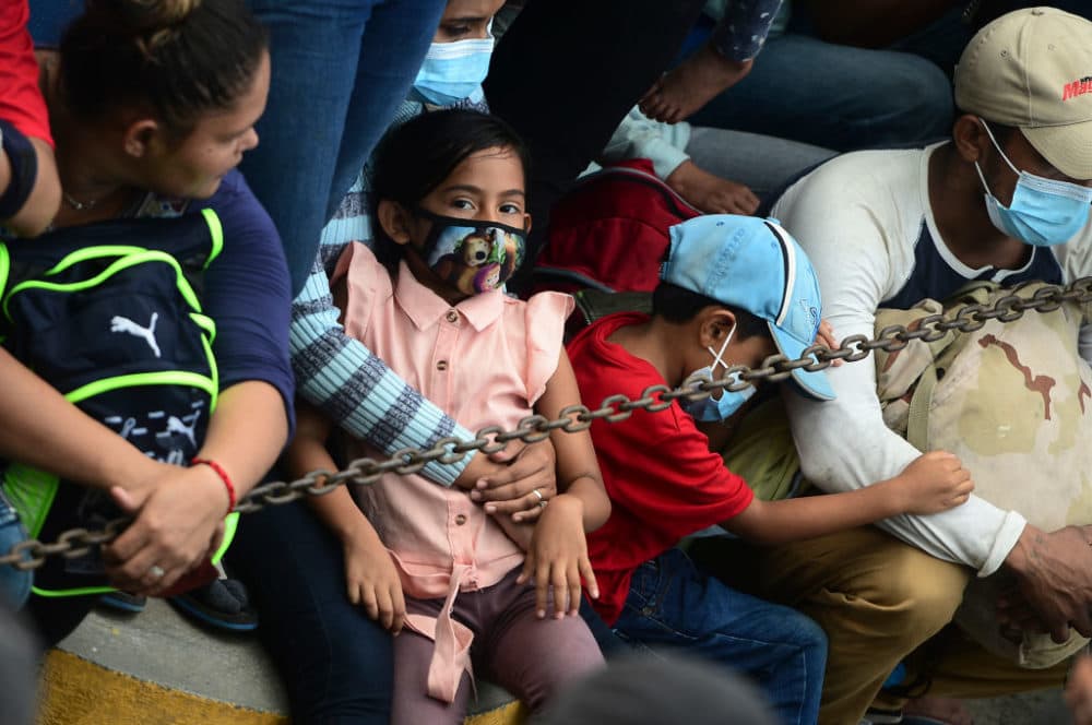 Honduran migrants remain in the borderline before breaking a police fence and entering Guatemala from Corinto, Honduras, on their way to the US, on October 1, 2020. (Orlando Sierra/AFP via Getty Images)