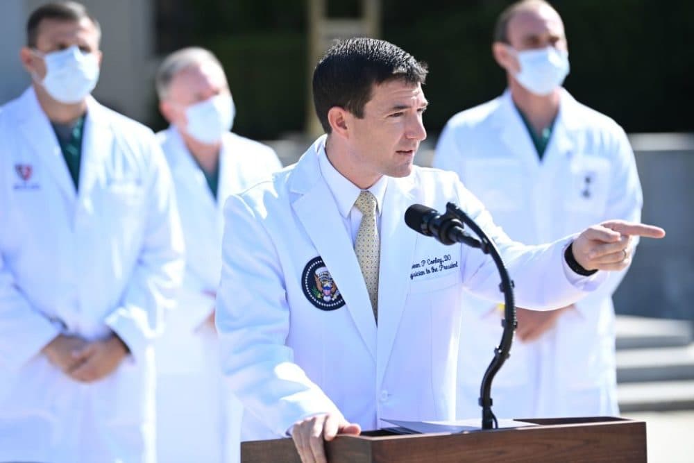 White House physician Sean Conley answers questions surrounded by other doctors, during an update on the condition of US President Donald Trump, on October 4, 2020, at Walter Reed Medical Center in Bethesda, Maryland. (Photo by BRENDAN SMIALOWSKI/AFP via Getty Images)