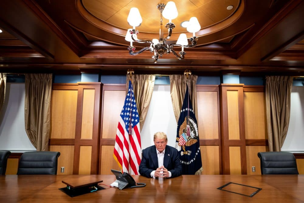 In this handout provided by The White House, President Trump participates in a phone call at Walter Reed National Military Medical Center on Oct. 4, 2020. (Tia Dufour/The White House via Getty Images)