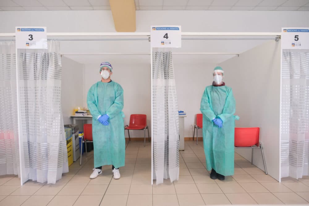 Two doctors posing in front of the rooms where coronavirus swab tests are carried out. in Padua, Italy October 19, 2020. (Roberto Silvino/NurPhoto via Getty Images)