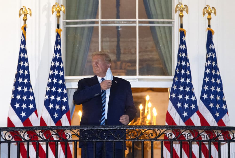 President Trump removes his mask upon return to the White House from Walter Reed National Military Medical Center on Oct. 05, 2020 in Washington, DC. Trump spent three days hospitalized for coronavirus. (Win McNamee/Getty Images)