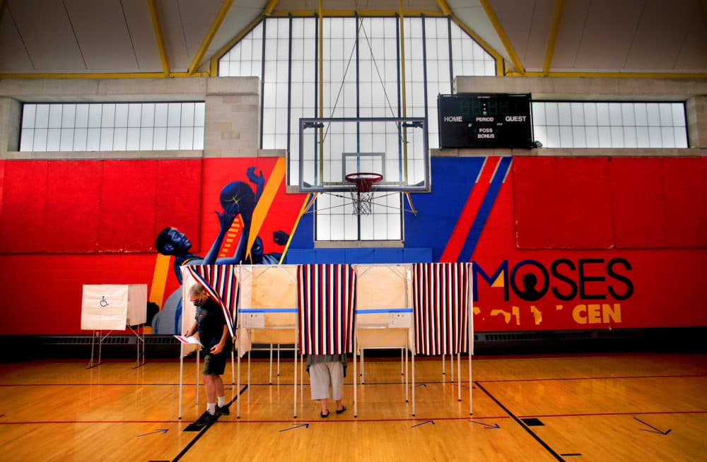 A voter leaves the booth inside the Moses Youth Center, the Precinct 2, Ward 3 polling place in Central Square in Cambridge on Sept. 1, 2020. (Lane Turner/The Boston Globe via Getty Images)