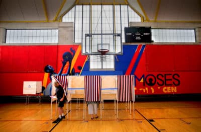 A voter leaves the booth inside the Moses Youth Center, the Precinct 2, Ward 3 polling place in Central Square in Cambridge on Sept. 1, 2020. (Lane Turner/The Boston Globe via Getty Images)