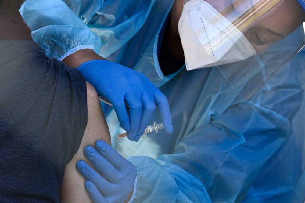 A flu vaccine is administered at a walk-up COVID-19 testing site in California. (Robyn Beck/AFP via Getty Images)