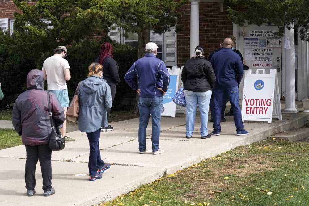 Cook County, Ill., residents wait in line for early voting and other county services. Oct. 13, 2020, at a county courthouse in Maywood, Ill. (Charles Rex Arbogast/AP)