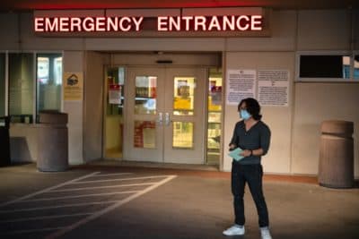 Adri Perez, with Common Cause 866ourvote, waits for a nurse to hand deliver an emergency ballot to a person hospitalized with COVID-19 at Las Palmas Medical Center. (Justin Hamel/AFP via Getty Images)
