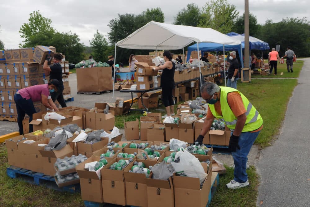 Volunteers prepare food donations from the Second Harvest Food Bank of Central Florida for distribution to needy families at a drive thru event at the New Jerusalem Church in Kissimmee, Florida. (Paul Hennessy/NurPhoto via Getty Images)
