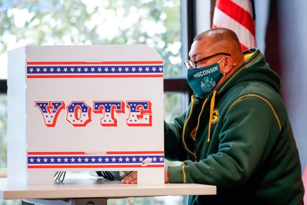 A man casts his ballot at Tippecanoe Library on the first day of in-person early voting on October 20, 2020 in Milwaukee, Wisconsin.  (Kamil Krzaczynski/AFP via Getty Images)