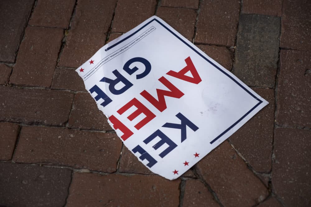 A torn poster on the ground outside the Massachusetts State House in Boston after skirmishes broke out during a demonstration by both Joe Biden and President Trump supporters on the day that the news broke that Biden was declared the winner of the U.S. presidential election Nov. 7, 2020.  (Jodi Hilton/NurPhoto via Getty Images)