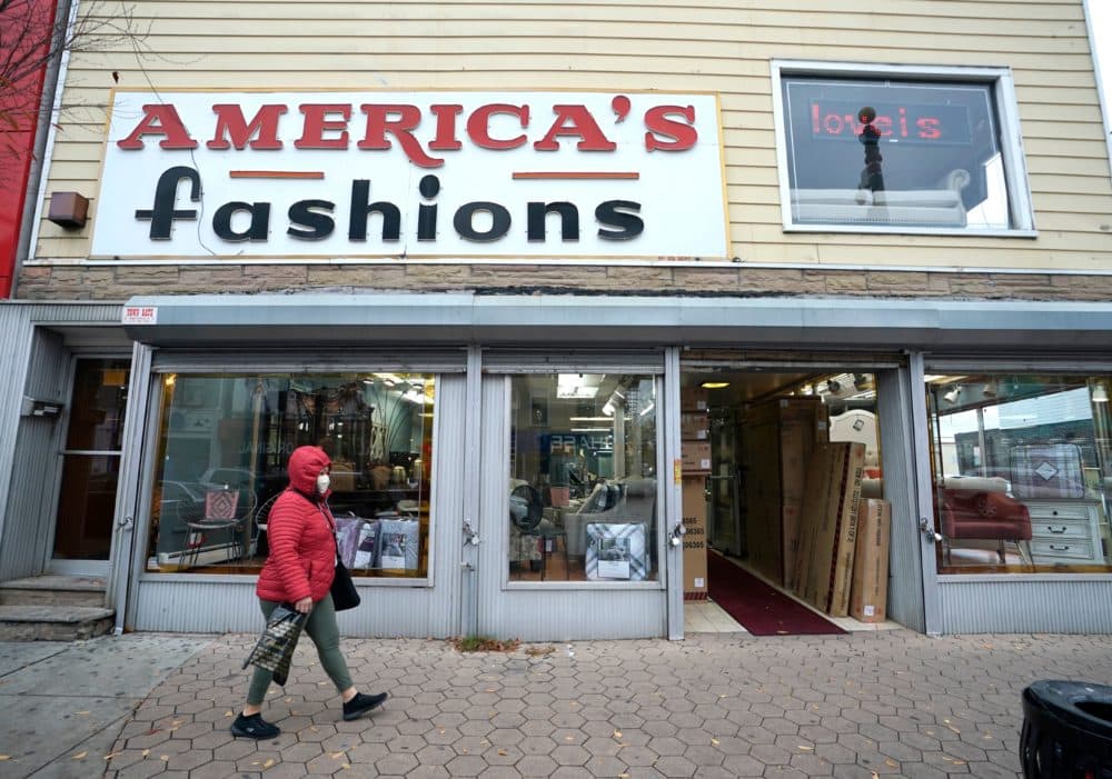 A person walks past a business in downtown Newark, New Jersey on Nov. 12, 2020. (Timoyhy A. Clary/AFP via Getty Images)