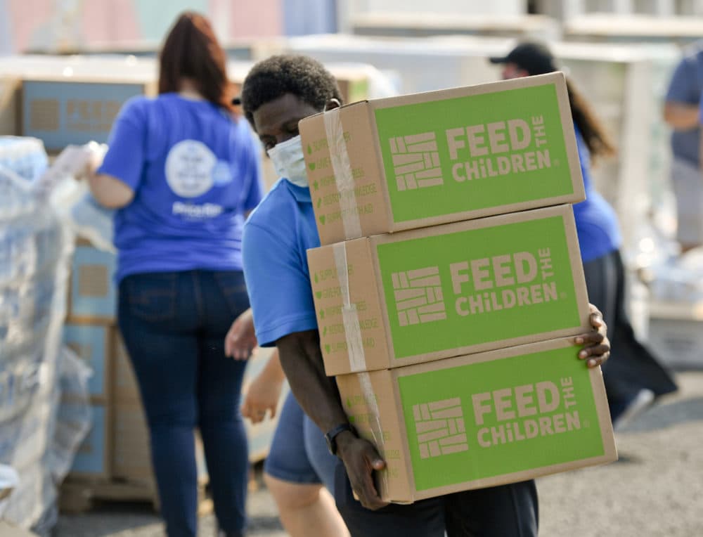 Quinton Robinson carries a stack of boxes from Feed The Children.At the Hope Rescue Mission in Reading, PA on August 27, 2020 where a food distribution was held from Feed the Children, in cooperation with Price Rite Marketplace, and Hope Rescue Mission. Families received boxes of food, personal care items, and two backpacks with school supplies. The distribution was done to meet the heightened need during the COVID-19 outbreak. (Ben Hasty/MediaNews Group/Reading Eagle via Getty Images)