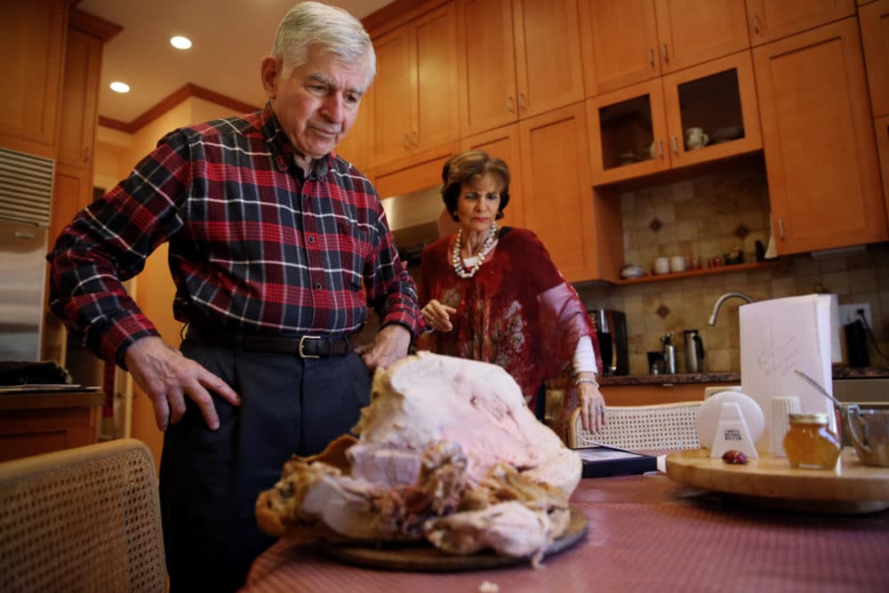 Former Massachusetts governor Michael Dukakis and his wife, Kitty, display a turkey carcass left at their home in Brookline on Nov. 25, 2017. (Craig F. Walker/The Boston Globe via Getty Images)