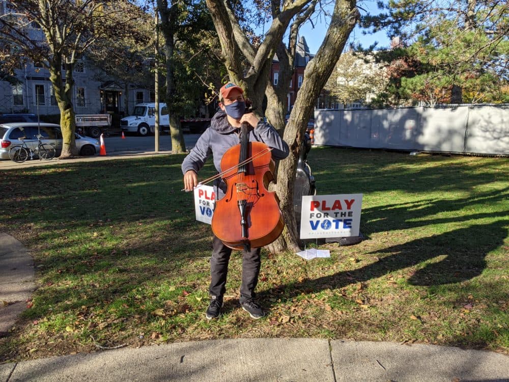Cellist Mike Block performs outside of a polling place in Somerville on election day 2020. (Jamie Bologna/WBUR)