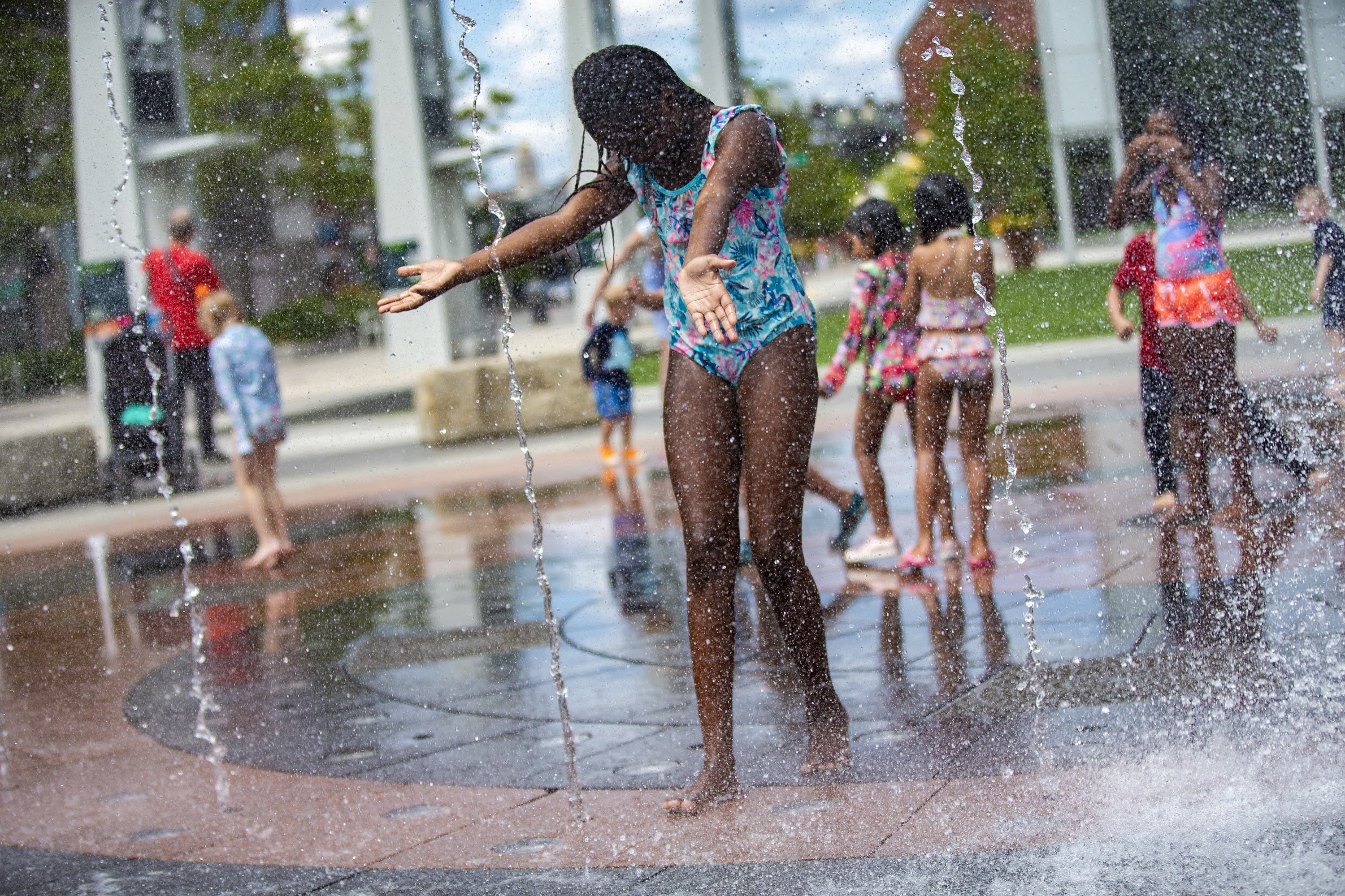 Children play in the Rings Fountain at the Rose Kennedy Greenway during a hot afternoon. (Jesse Costa/WBUR)
