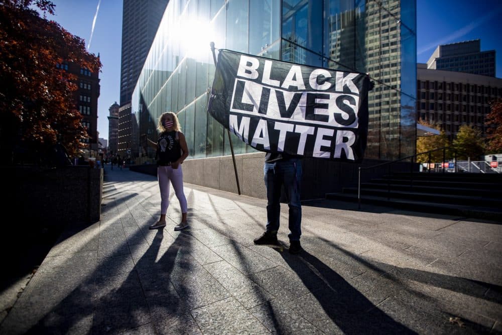 Black Lives Matter rally participants stand near the Government Center MBTA station in Boston. (Jesse Costa/WBUR)