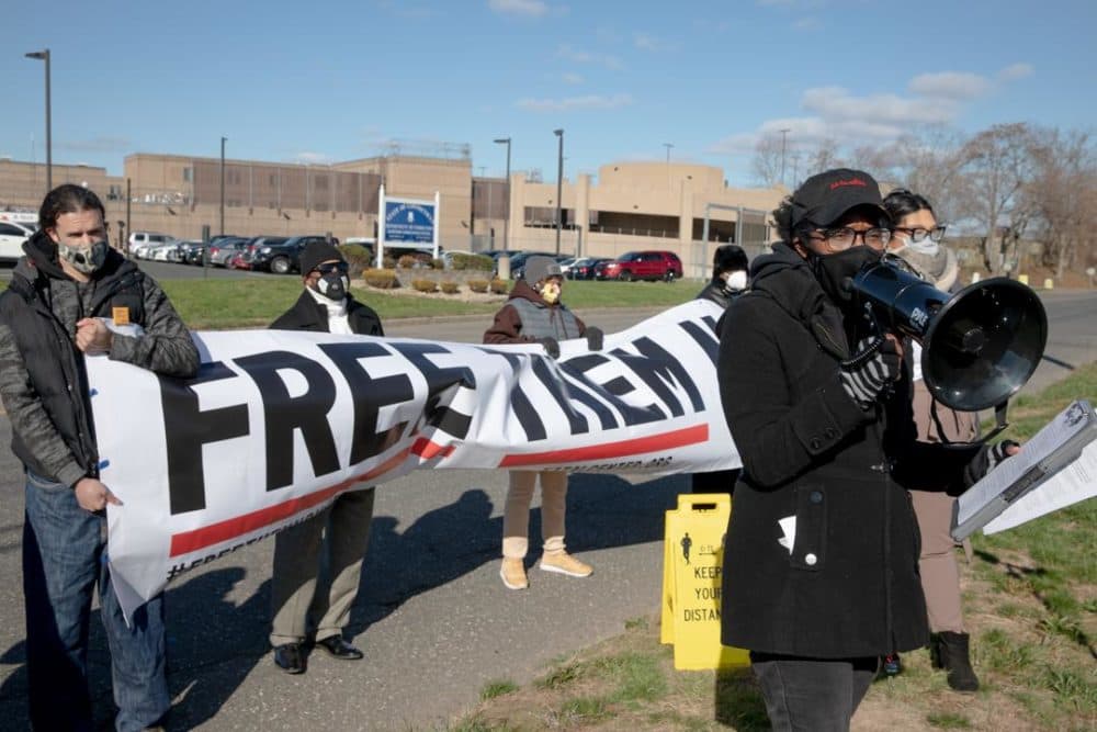 Kenyatta Thompson (right), a lead organizer of Katal Center, asks for the release of incarcerated individuals outside the Hartford Correctional Center. (Yehyun Kim/Connecticut Mirror)