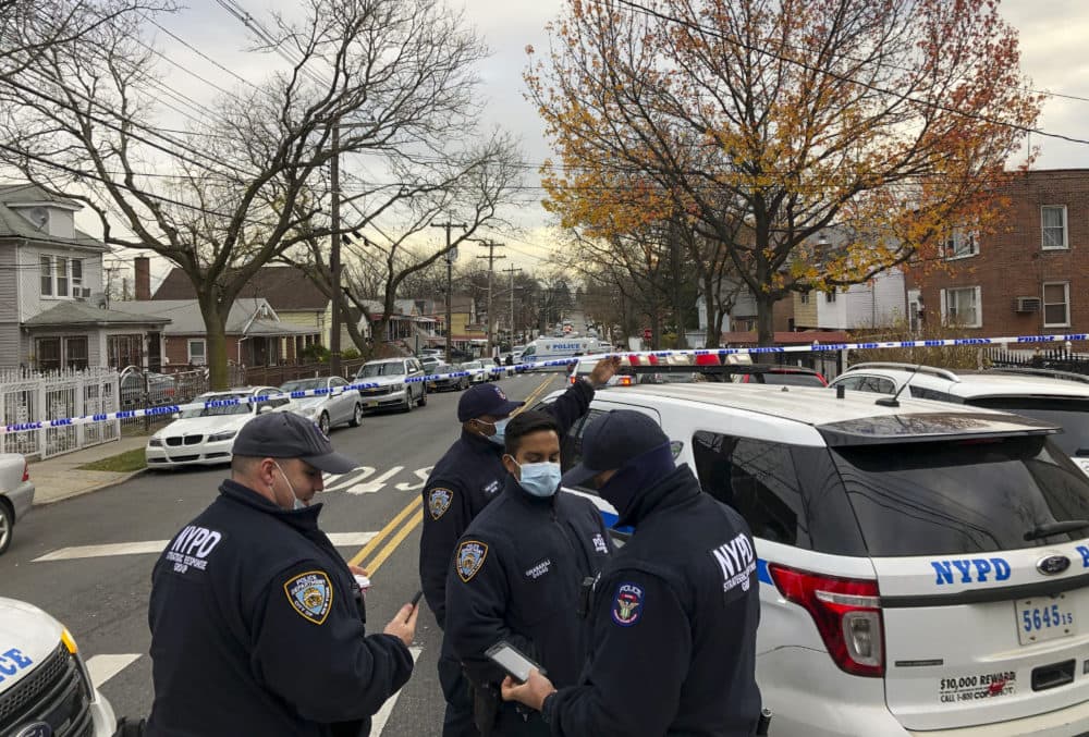 New York Police officers block off the street near the scene where a suspect was killed during a shootout with U.S. marshals in the Bronx that left two officers wounded, Friday, Dec. 4, 2020, in New York. The suspect, 35-year-old Andre Sterling, was wanted for shooting a Massachusetts state trooper in the hand on Nov. 20 during a traffic stop in Hyannis, Mass. (AP Photo/Mark Lennihan)