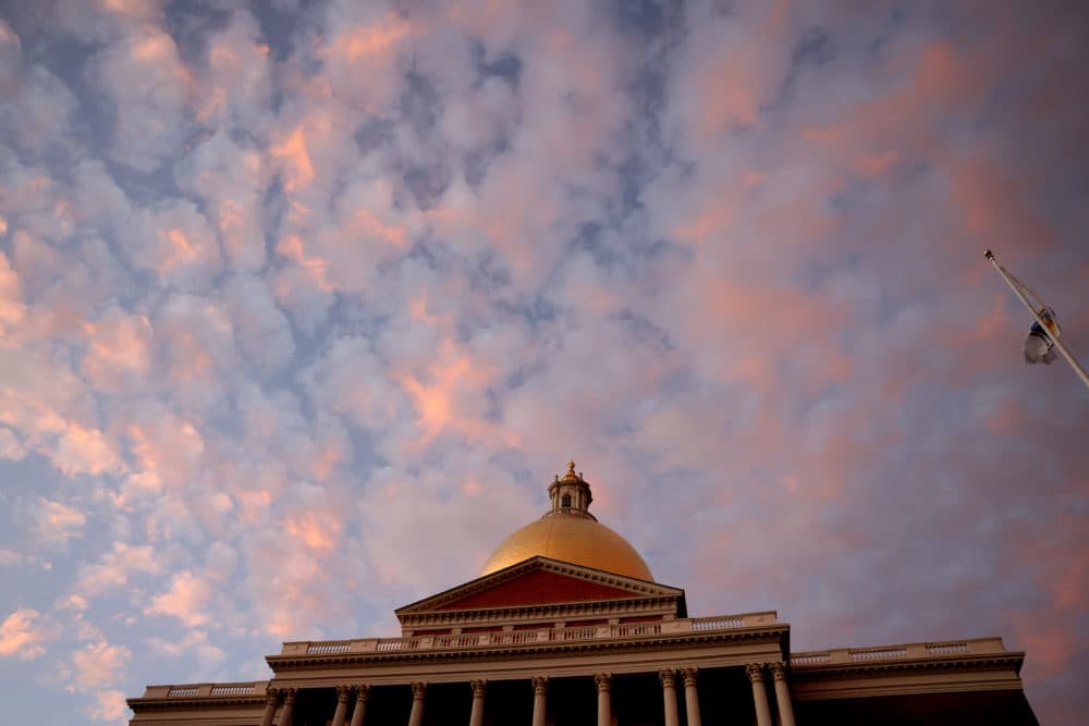 The sunset is seen above the Massachusetts State House in Boston on Dec. 1, 2020. (Jessica Rinaldi/The Boston Globe via Getty Images)