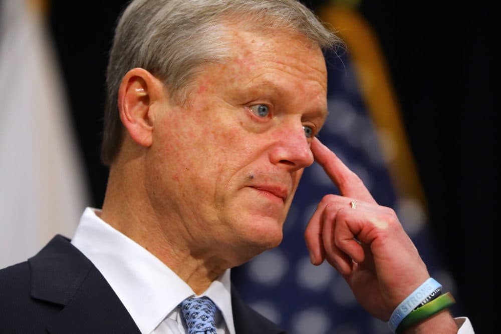 Gov. Charlie Baker wipes his eye after saying &quot;I haven't had a meal with my Dad since February&quot; during a press conference in the Gardner Auditorium in the Massachusetts State House in Boston on Dec. 7, 2020. (Pat Greenhouse/The Boston Globe via Getty Images)