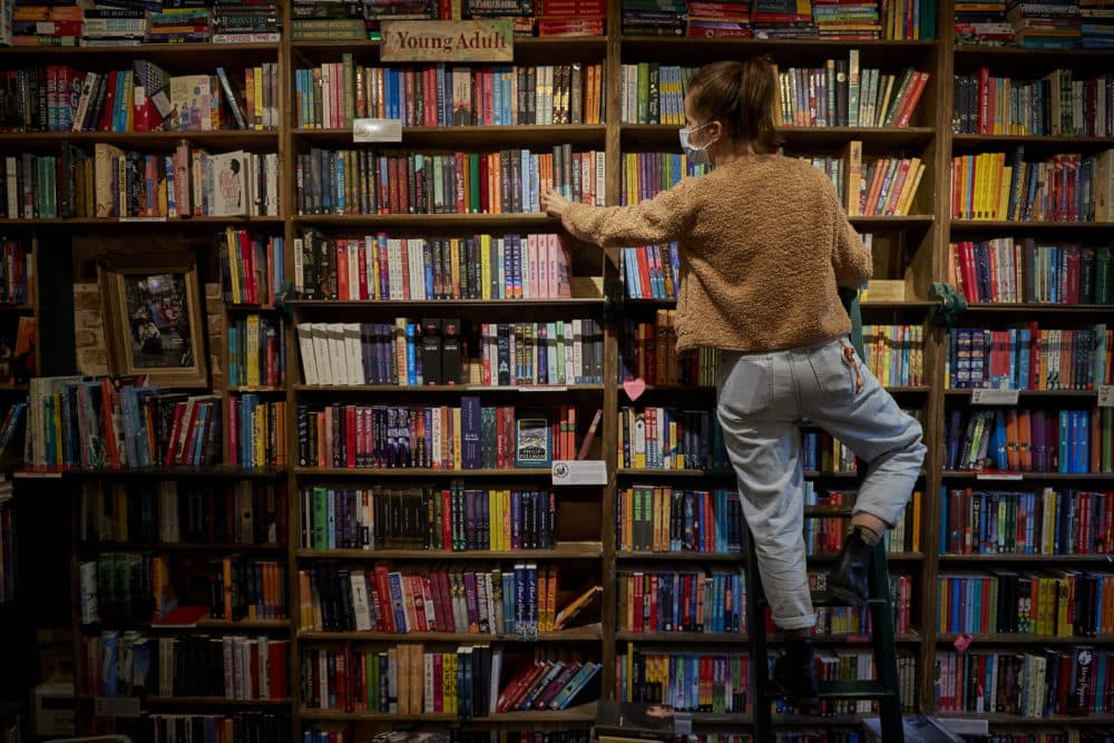 A staff member picks out a book for an order inside Shakespeare and Company Bookshop on Nov. 4, 2020 in Paris, France. (Kiran Ridley/Getty Images)