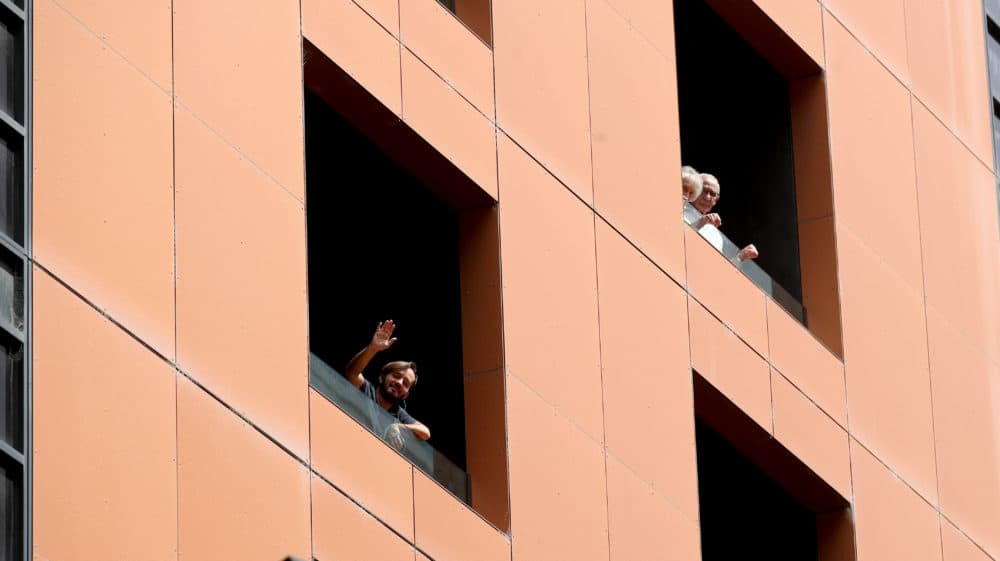 Quarantined hotel quests on the balcony of the Peppers on Waymouth Hotel on November 18, 2020 in Adelaide, Australia. (Kelly Barnes/Getty Images)