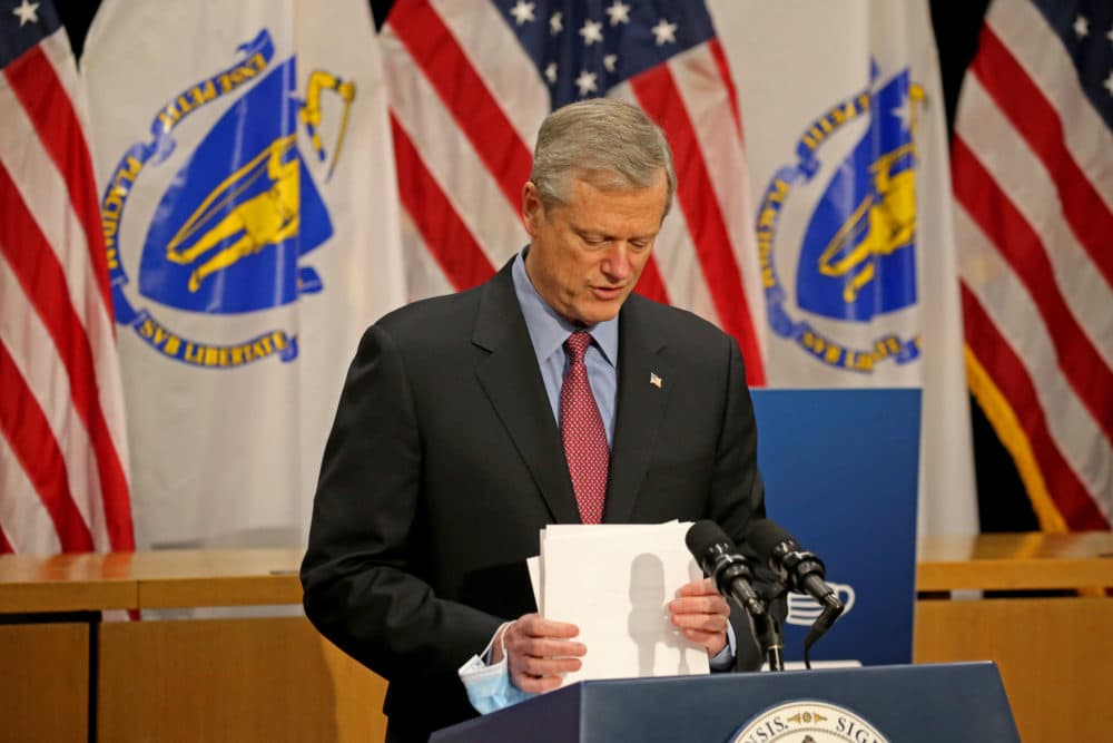 Gov. Charlie Baker finishes up his written remarks as he speaks to the media on the Covid-19 situation in Mass. on Dec. 22. (Stuart Cahill/MediaNews Group/Boston Herald via pool)