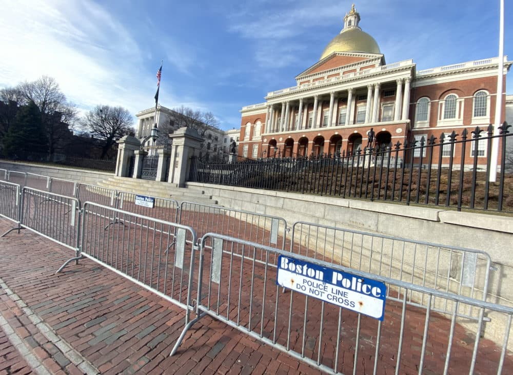 Two rows of crowd-control fencing stretched down the sidewalk in front of the State House front steps Tuesday afternoon. (Sam Doran/SHNS)