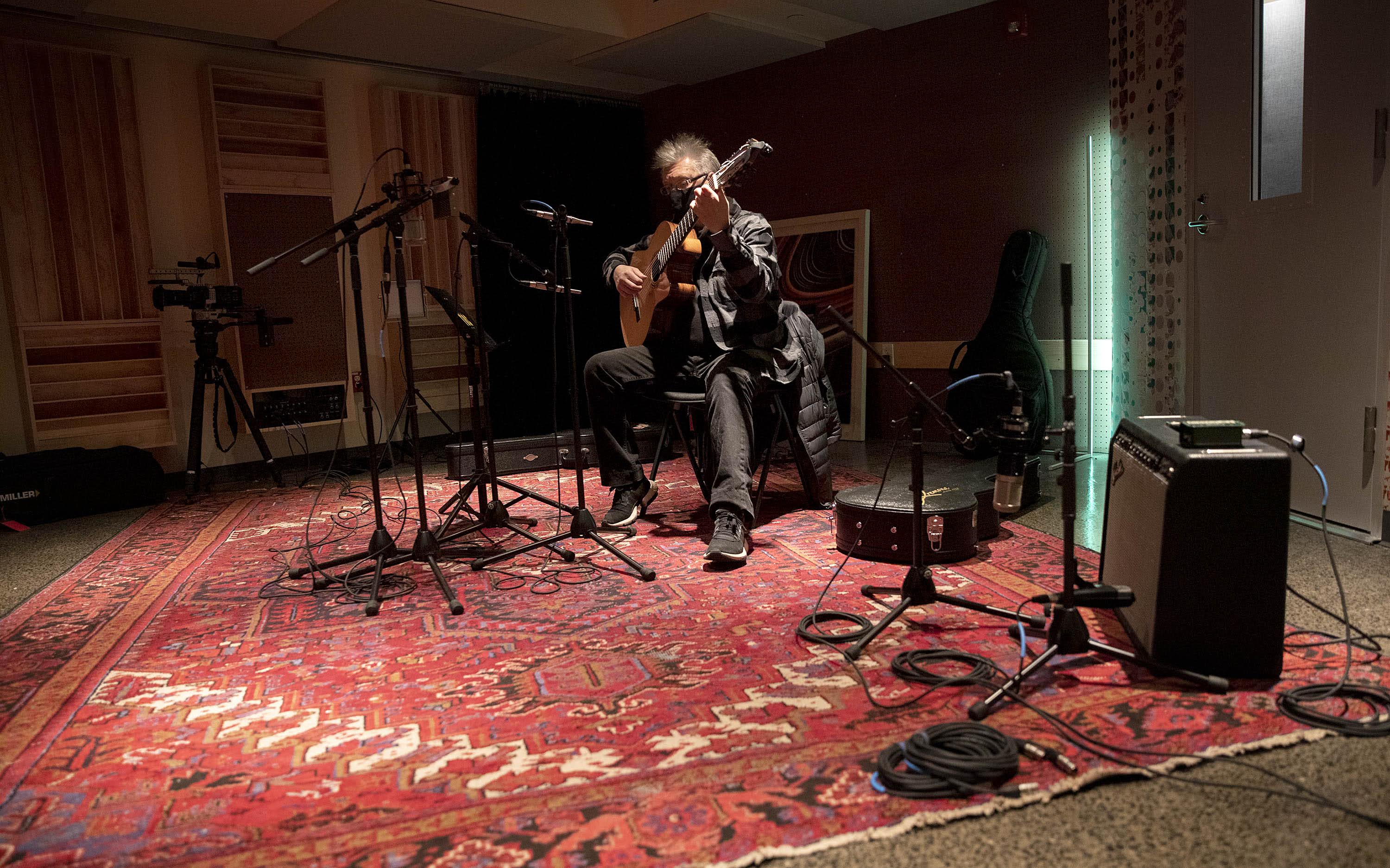 Musician and composer Claudio Ragazzi plays his guitar in the new Studio B at The Record Co. (Robin Lubbock/WBUR)