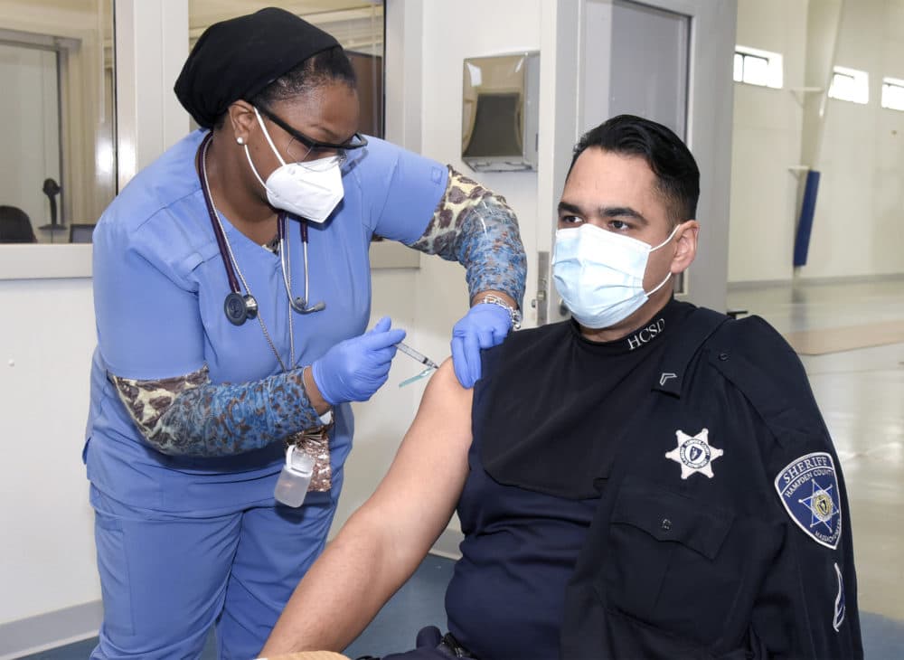 A Hampden County Sheriff's Department employee is given the vaccine by members of the department's medical team. (Courtesy Mark M.Murray/Hampden County Sheriff's Department)