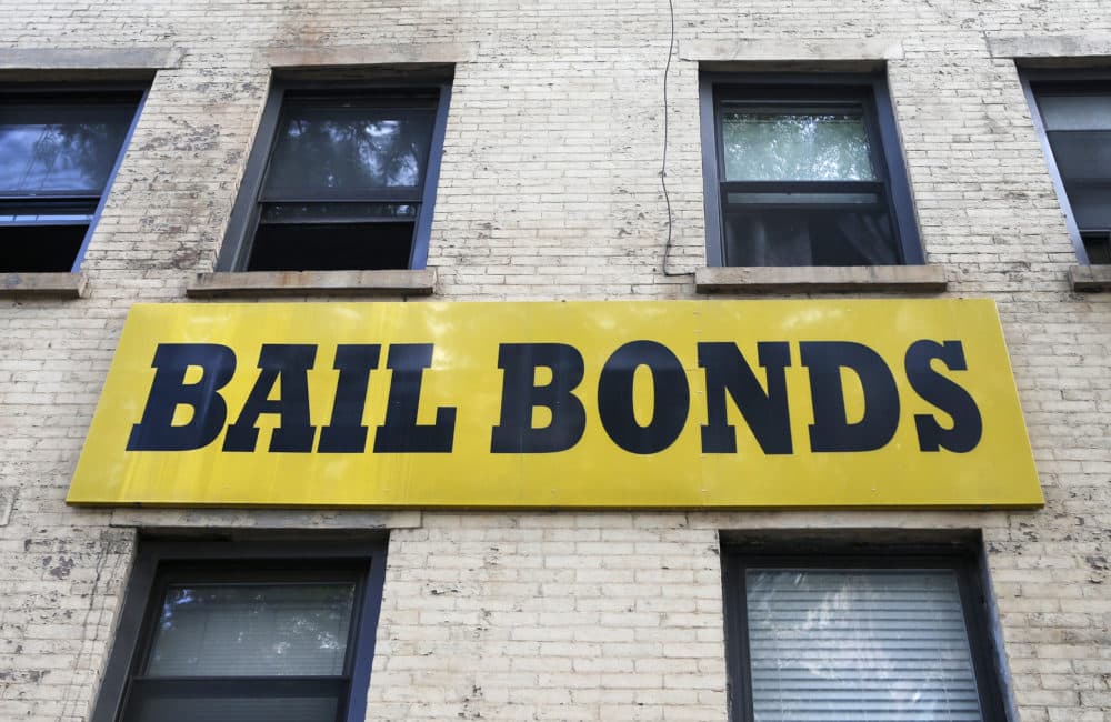 A bail bonds sign hangs on the side of a bail bonds business. (Kathy Willens/AP)