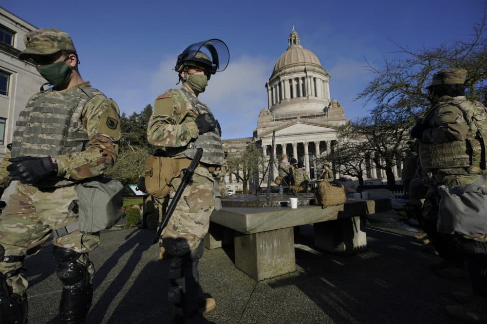 Members of the Washington National Guard stand at a sundial near the Legislative Building, Sunday, Jan. 10, 2021, at the Capitol in Olympia, Wash. Governors in some states have called out the National Guard, declared states of emergency and closed their capitols over concerns about potentially violent protests. (Ted S. Warren/AP)