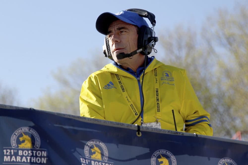In this 2017 file photo, Race Director Dave McGillivray looks on from the platform at the start of the Boston Marathon in Hopkinton, Mass. Since the 2021 Boston Marathon is on hold until fall, McGillivray has been tapped by the state of Massachusetts to run mass vaccination operations at Gillette Stadium and Fenway Park. (Mary Schwalm/AP File)