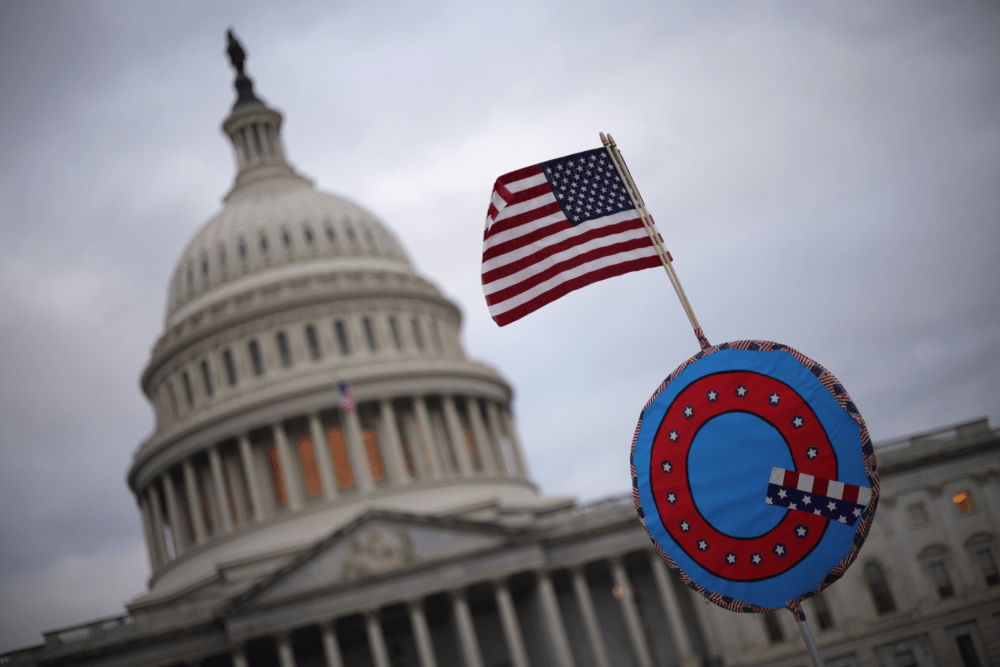 Supporters of former President Trump fly a U.S. flag with a symbol from the group QAnon as they gather outside the U.S. Capitol Jan. 06, 2021 in Washington, D.C. (Win McNamee/Getty Images)