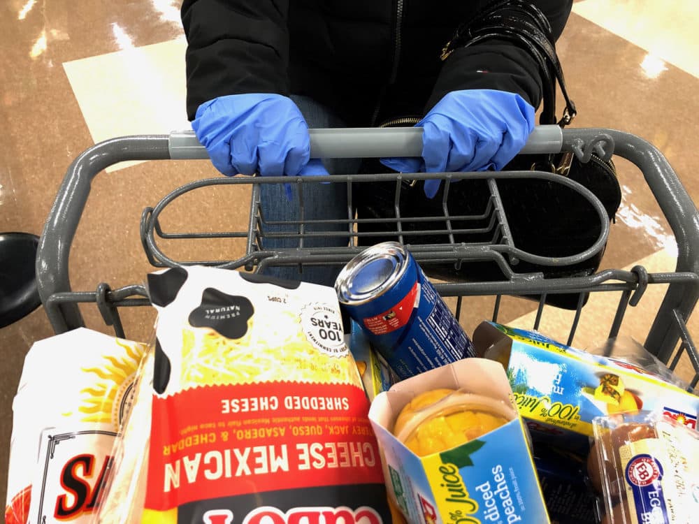 Many customers wear gloves while shopping at a supermarket in Saugus, Massachusetts on March 13, 2020. (Joseph Prezioso/AFP via Getty Images)