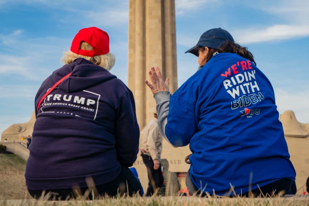 A President Donald Trump and a former Vice President Joe Biden supporter converse before the Joe Biden Campaign Rally at the National World War I Museum and Memorial on March 7, 2020 in Kansas City, Missouri. (Kyle Rivas/Getty Images)