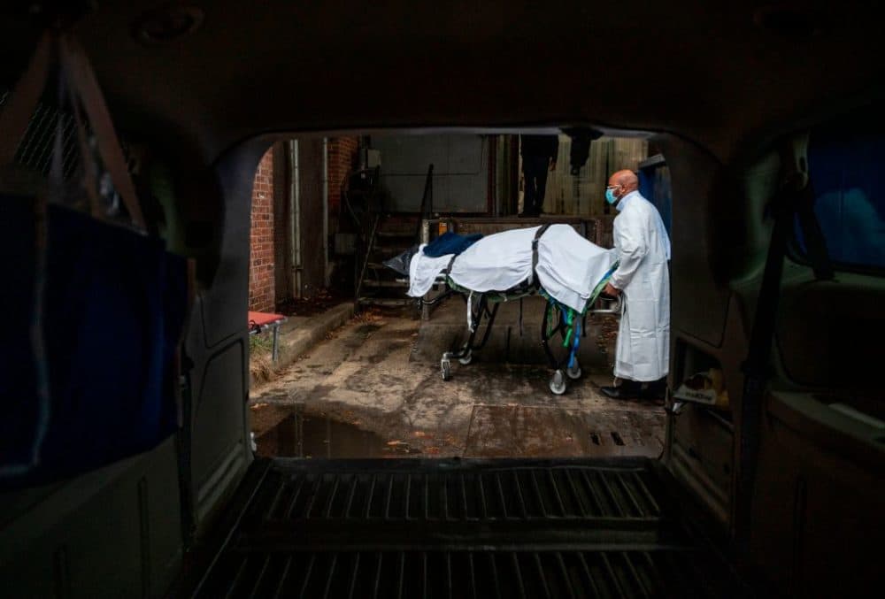 Maryland Cremation Services transporter Reggie Elliott brings the remains of a COVID-19 victim to his van from the hospital's morgue in Baltimore, Maryland, on Dec. 24, 2020. (Andrew Caballero-Reynolds/AFP/Getty Images)