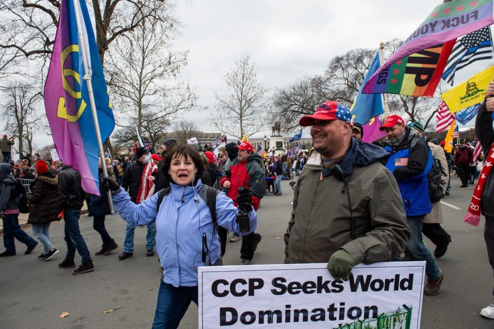 Natick town meeting member Sue Ianni and Mark Sahady, along with other supporters of President Trump, march through the streets of Washington, D.C. as they make their way to the Capitol building on Jan. 6, 2021.(Joseph Prezioso /AFP via Getty Images)