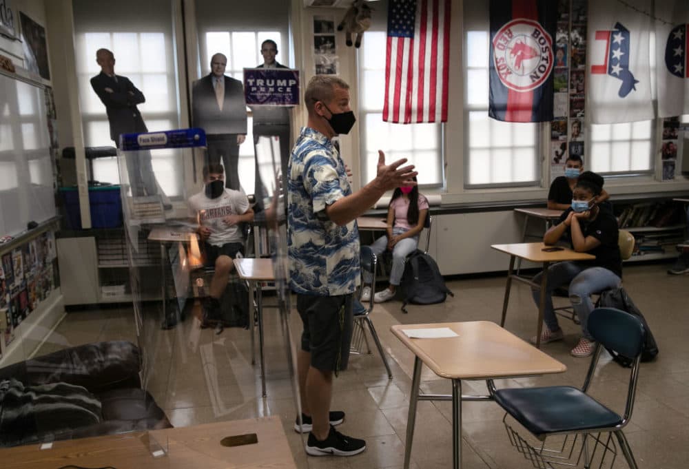 Honors civics teacher Mike Brown discusses the presidential election with masked students on the first day of school at Stamford High School on Sept. 8, 2020 in Stamford, Connecticut. (John Moore/Getty Images)