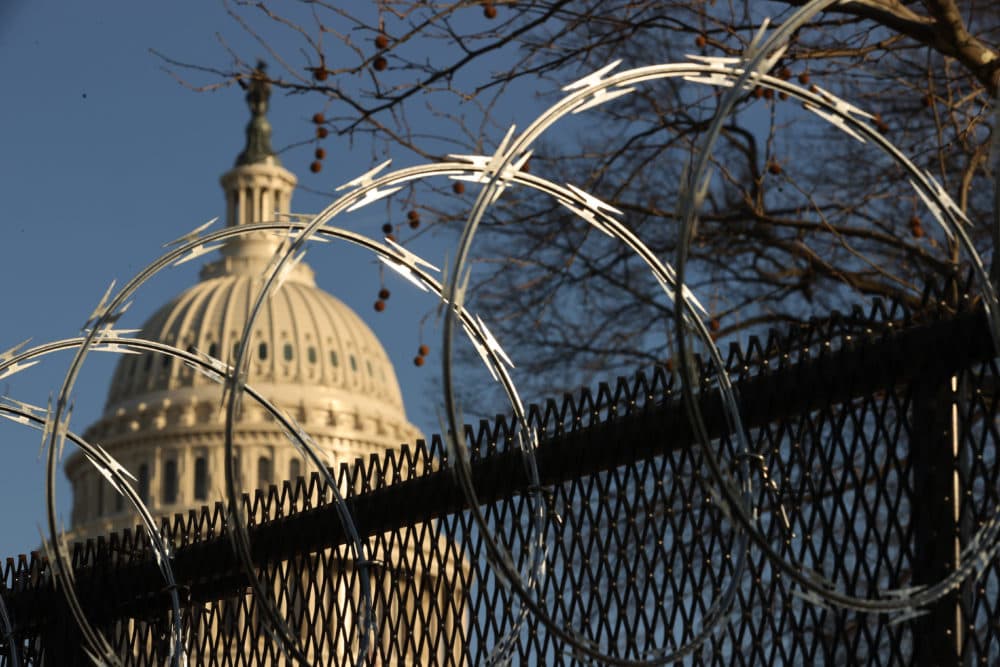 Concertina razor wire tops the 8-foot &quot;non-scalable&quot; fence that surrounds the U.S. Capitol on the day after the House voted to impeach former President Trump for the second time. (Chip Somodevilla/Getty Images)