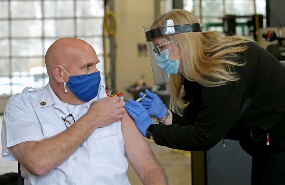 Norwood Fire Chief George Morrice receives a COVID-19 vaccine from registered nurse Stacey Lane on January 11, 2021 in Norwood, Massachusetts. (Matt Stone/Boston Herald via Getty Images)