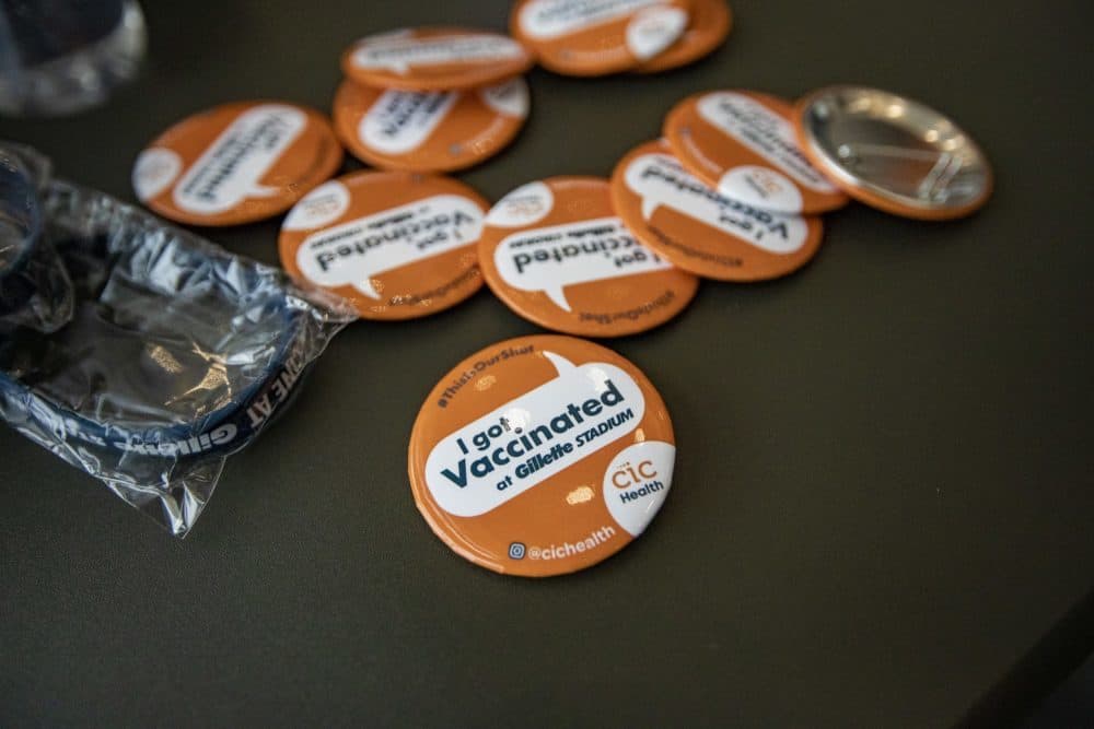 Buttons and wristbands were handed out to vaccine recipients at the Gillette Stadium COVID-19 vaccination site in 2021. (Jesse Costa/WBUR)