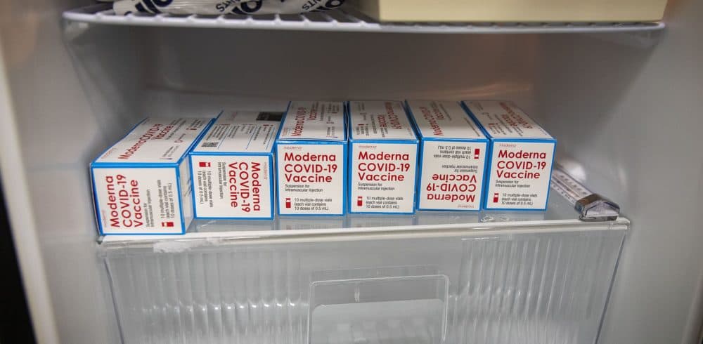 Boxes of COVID-19 vaccine in a refrigeration unit at InterMed Associates in Webster. (Robin Lubbock/WBUR)