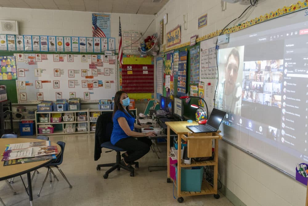 Kindergarten teacher Christine Figueroa wears a mask as she watches a gym class where her students are participating remotely and in person at school in Oct. 2020 in Yonkers, New York. (Mary Altaffer/AP)