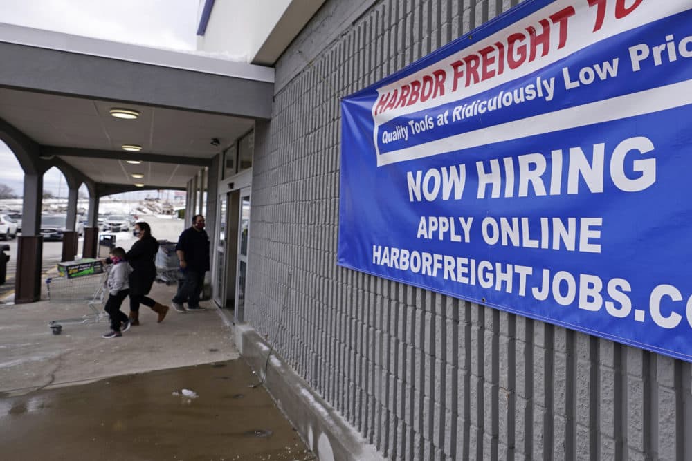 In this Dec. 10, 2020 file photo, a &quot;Now Hiring&quot; sign hangs on the front wall of a Harbor Freight Tools store in Manchester, N.H. (Charles Krupa/AP File)