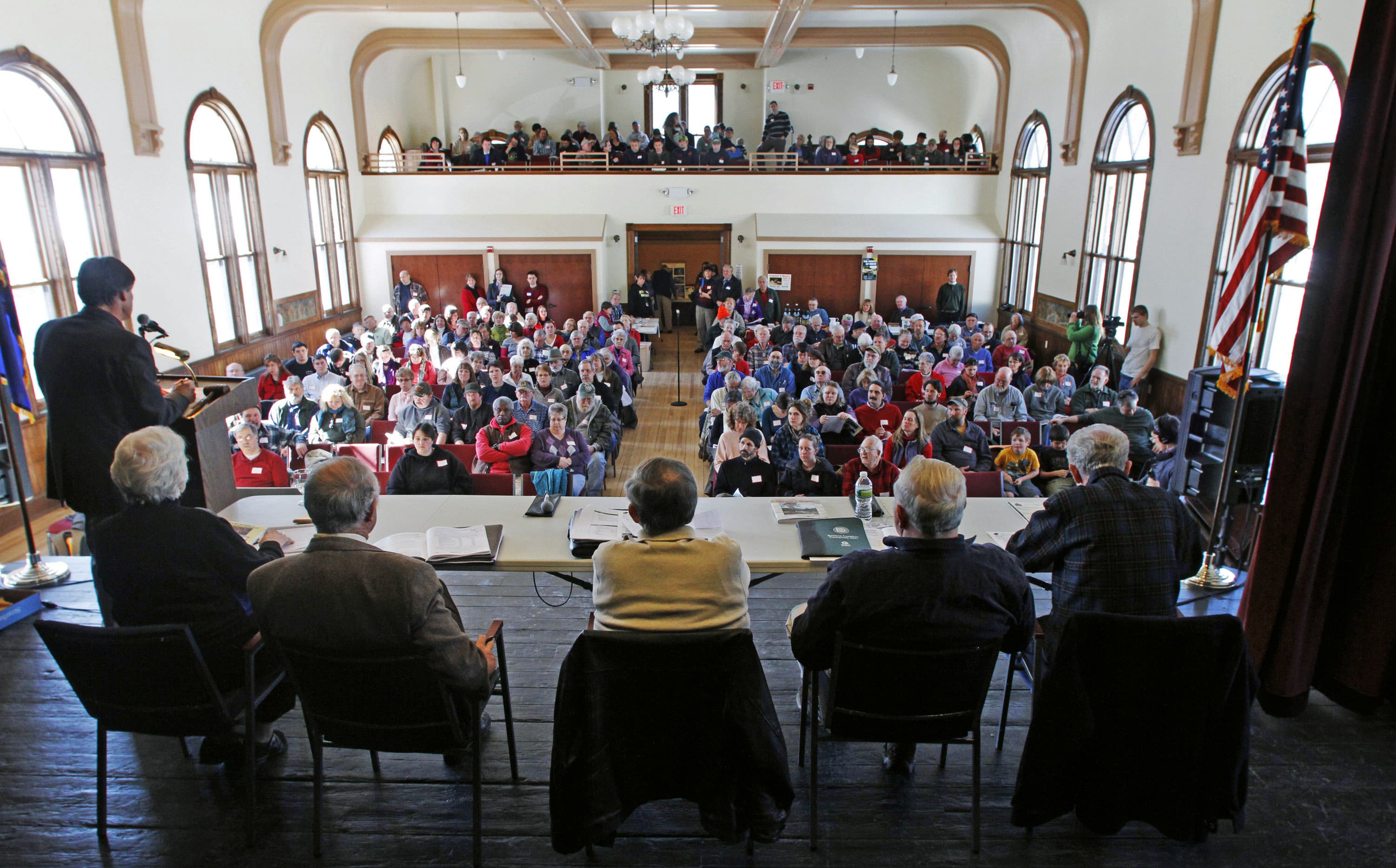 In this March 6, 2012, file photo, officials preside over the annual town meeting in Bethel, Vt. The COVID-19 pandemic is disrupting New England town meetings in 2021, a tradition where citizens gather to debate and decide on local issues. (Toby Talbot/AP File)