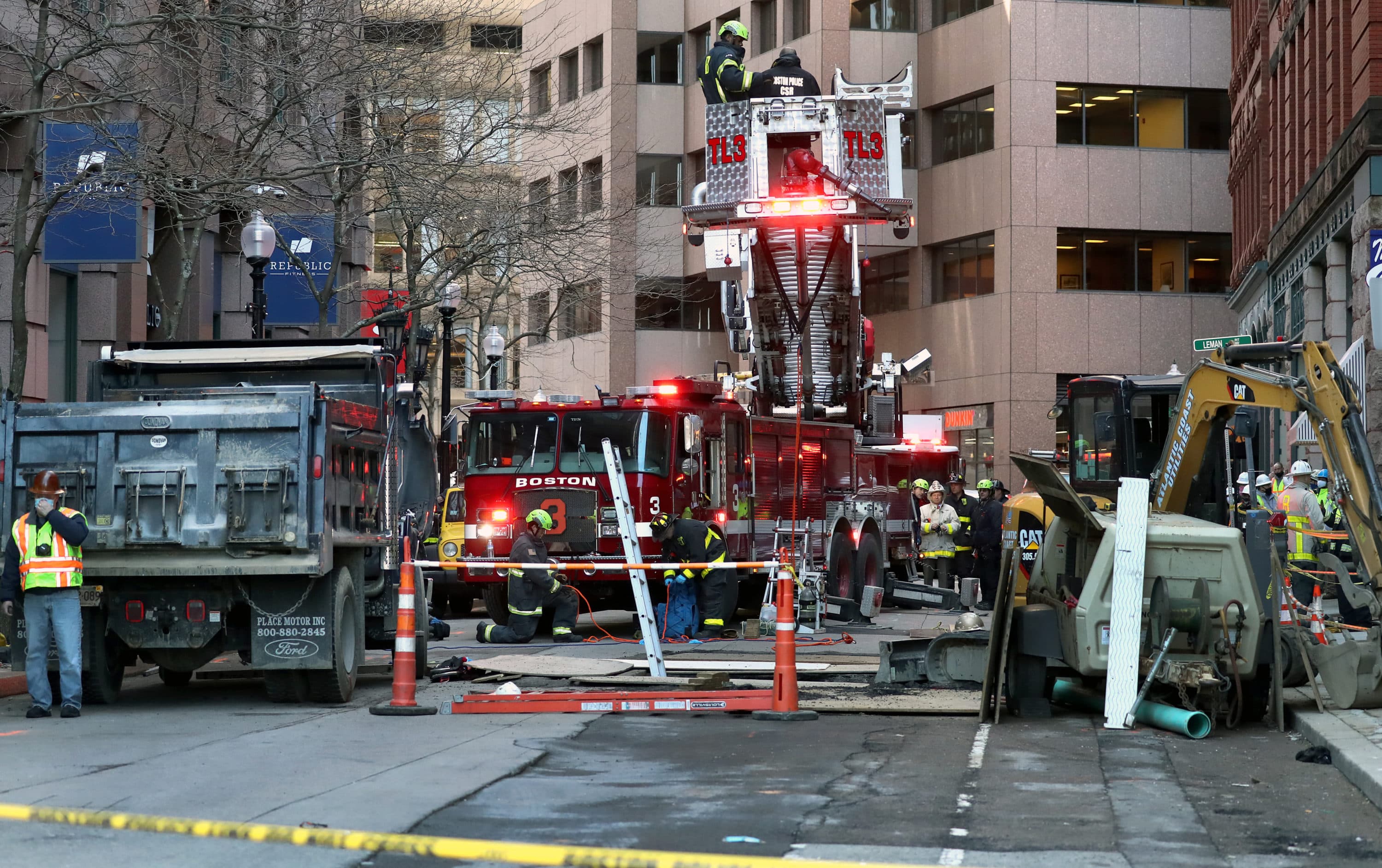 The truck involved in the crash is pictured on the left as firefighters and first responders stand at the scene in downtown Boston on Feb. 24, 2021. (David L. Ryan/The Boston Globe via Getty Images)